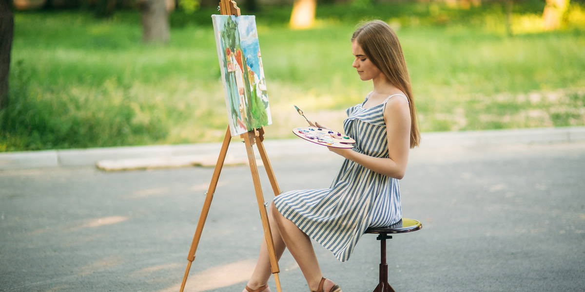 Woman in a Sun Dress Painting Art in the Middle of the Road