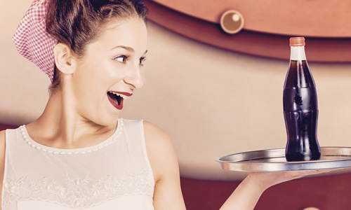 elated retro woman holding a cola on a tray