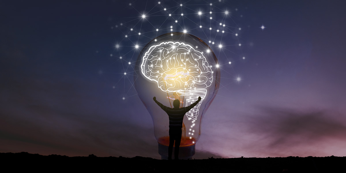 Abstract: Big Light Bulb With Brain Inside against the Night Sky Victorious Person