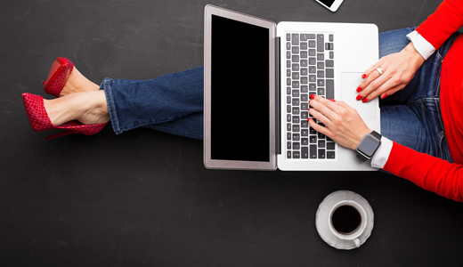 Woman with a Laptop and smart watch ready to do some online shopping. 